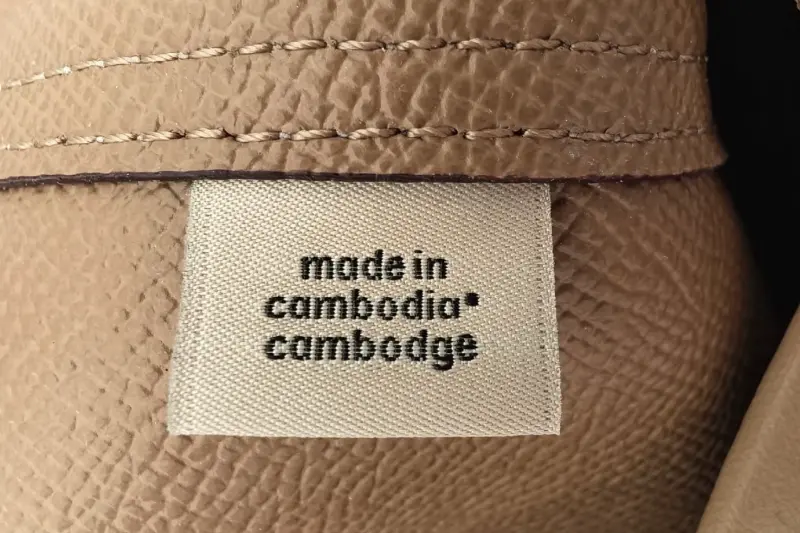 Coach bag interior fabric tag showing "Made in Cambodia" country of origin label