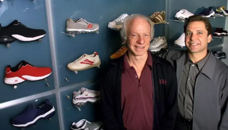 Skechers founder and CEO Robert Greenberg with son Michael Greenberg, President of Skechers, posing in an early Skechers showroom