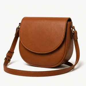 Curved saddle bag with flap and crossbody strap